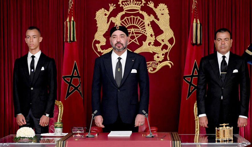 In this photo dated Sunday, July 29, 2018, released by the state news agency, Moroccan News Agency (MAP), and provided by the Moroccan Royal Palace, King Mohammed VI, is flanked by his brother Prince Moulay Rachid, right, and Crown Prince Moulay Hassan, during the annual Throne Speech, in Al-Hoceima, Morocco. Mohammed VI has criticized the North African kingdom's social development programs as overlapping, uncoordinated and missing target populations in a speech from the northern town that has been the epicenter for social unrest. (Moroccan Royal Palace via AP)