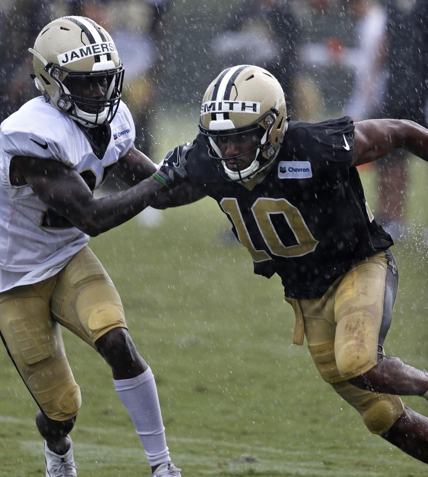 New Orleans Saints wide receiver Tre'Quan Smith (10) goes through drills against defensive back Natrell Jamerson at their NFL football training facility in Metairie, La., Monday, July 30, 2018. (AP Photo/Gerald Herbert)