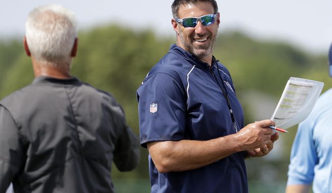Tennessee Titans head coach Mike Vrabel, right, talks with secondary coach Kerry Coombs during NFL football training camp Monday, July 30, 2018, in Nashville, Tenn. (AP Photo/Mark Humphrey)