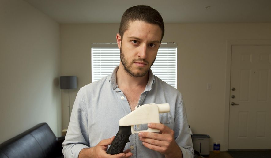 In this May 10, 2013, file photo, Cody Wilson, the founder of Defense Distributed, shows a plastic handgun made on a 3D-printer at his home in Austin, Texas. (Jay Janner/Austin American-Statesman via AP, File)