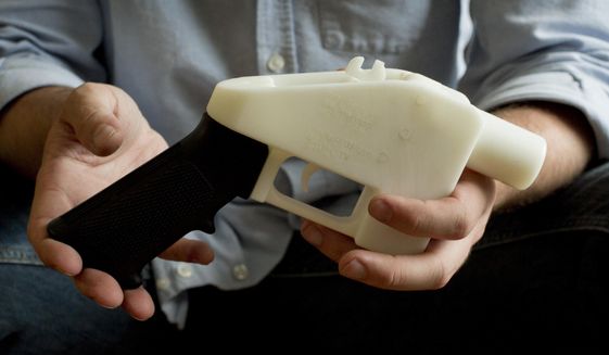 In this file photo, Cody Wilson holds what he calls a Liberator pistol that was completely made on a 3-D-printer at his home in Austin, Texas. (Jay Janner/Austin American-Statesman via AP, File) **FILE**