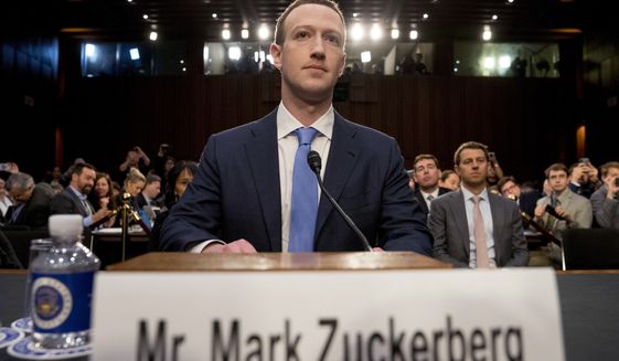 Facebook CEO Mark Zuckerberg arrives to testify before a joint hearing of the Commerce and Judiciary Committees on Capitol Hill in Washington about the use of Facebook data to target American voters in the 2016 election on April 10, 2018. (Associated Press) **FILE**