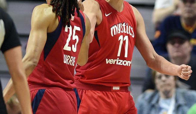 FILE - In this June 13, 2018, file photo, Washington Mystics forward Elena Delle Donne (11) celebrates with teammate Monique Currie (25) after being fouled by Connecticut Sun forward Chiney Ogwumike during the second half of a WNBA basketball game in Uncasville, Conn. All 12 teams will play eight or nine games over the next few weeks setting up for one of the most exciting final few weeks of the regular season in league history with only four losses separating second place Atlanta from ninth-place Las Vegas. “It’s going to be a wild last few weeks,” said Elena Delle Donne. (Sean D. Elliot/The Day via AP, File)