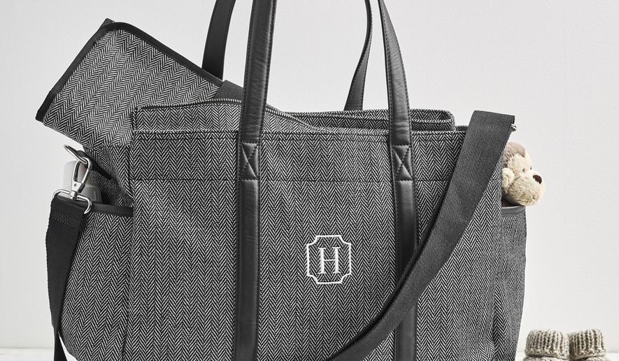 This undated photo provided by Potter Barn Kids shows one of their designer diaper bags with herringbone. Diaper bags today are far more style-savvy than in the past. Tailored patterns like houndstooth and herringbone, leather or vegan leather trims, and smart hardware all give trendy baby gear panache along with purpose. (Pottery Barn Kids via AP)