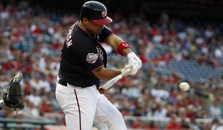 Washington Nationals&#39; Ryan Zimmerman hits an RBI single during the first inning of the team&#39;s baseball game against the New York Mets at Nationals Park, Tuesday, July 31, 2018, in Washington. It was Zimmerman&#39;s 1,695th hit, a new franchise record. (AP Photo/Alex Brandon)
