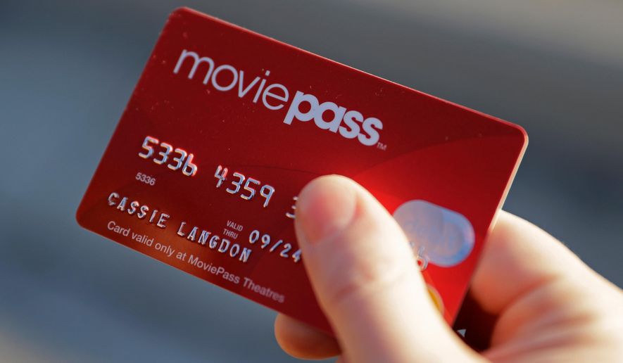 FILE - In this Jan. 30, 2018, file photo, Cassie Langdon holds her MoviePass card outside AMC Indianapolis 17 theatre in Indianapolis. MoviePass, the discount service for movie tickets, is raising prices by 50 percent and barring viewings of most major releases during the first two weeks. (AP Photo/Darron Cummings, File)