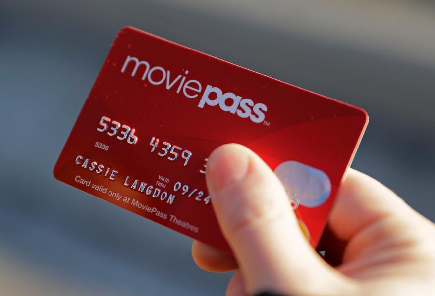 FILE - In this Jan. 30, 2018, file photo, Cassie Langdon holds her MoviePass card outside AMC Indianapolis 17 theatre in Indianapolis. MoviePass, the discount service for movie tickets, is raising prices by 50 percent and barring viewings of most major releases during the first two weeks. (AP Photo/Darron Cummings, File)