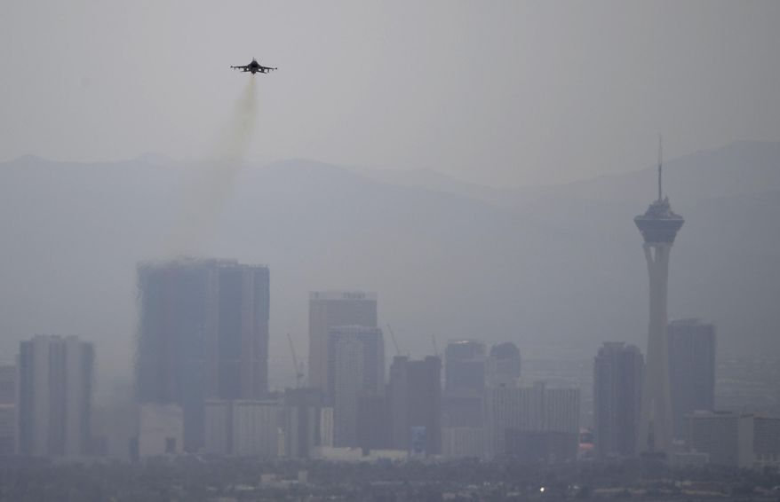 A fighter jet takes off from Nellis Air Force Base as a haze blankets the Las Vegas valley, Tuesday, July 31, 2018, in Las Vegas. Dense smoke from a series of wildfires burning in California has triggered air quality alerts across more than a 400-mile stretch of Nevada from Reno to Las Vegas. (AP Photo/John Locher)