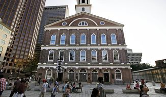 FILE - In this Aug. 21, 2017, file photo, pedestrians walk past Faneuil Hall in Boston. In an open letter to Boston Mayor Marty Walsh, dated July 30, 2018, some black Bostonians are threatening a boycott because the building&#39;s 18th-century namesake was a slave owner. (AP Photo/Charles Krupa, File)
