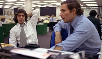 FILE - In this May 7, 1973 file photo, reporters Bob Woodward, right, and Carl Bernstein, whose reporting of the Watergate case won them a Pulitzer Prize, sit in the newsroom of the Washington Post in Washington. More than 40 years after they became the world’s most famous journalism duo, Bob Woodward and Carl Bernstein are still making news. Bernstein was among three CNN reporters who last week broke the story of former Donald Trump lawyer Michael Cohen’s allegation that Trump had advance knowledge of the June 2016 meeting between representatives of his campaign and Russian officials. On Tuesday, July 31, 2018, Woodward’s upcoming “Fear: Inside the Trump White House” was No. 1 on Amazon.com. (AP Photo, File)