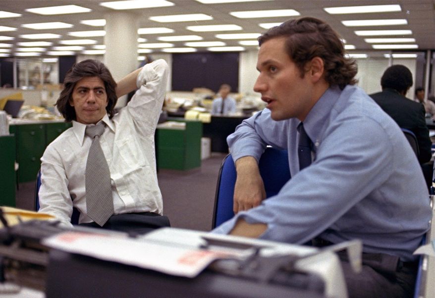 FILE - In this May 7, 1973 file photo, reporters Bob Woodward, right, and Carl Bernstein, whose reporting of the Watergate case won them a Pulitzer Prize, sit in the newsroom of the Washington Post in Washington. More than 40 years after they became the world’s most famous journalism duo, Bob Woodward and Carl Bernstein are still making news. Bernstein was among three CNN reporters who last week broke the story of former Donald Trump lawyer Michael Cohen’s allegation that Trump had advance knowledge of the June 2016 meeting between representatives of his campaign and Russian officials. On Tuesday, July 31, 2018, Woodward’s upcoming “Fear: Inside the Trump White House” was No. 1 on Amazon.com. (AP Photo, File)