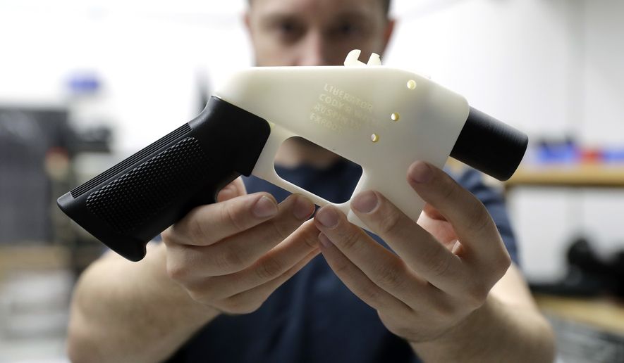 Cody Wilson, with Defense Distributed, holds a 3D-printed gun called the Liberator at his shop, Wednesday, Aug. 1, 2018, in Austin, Texas. A federal judge in Seattle  issued a temporary restraining order Tuesday to stop the release of blueprints to make untraceable and undetectable 3D-printed plastic guns. (AP Photo/Eric Gay)