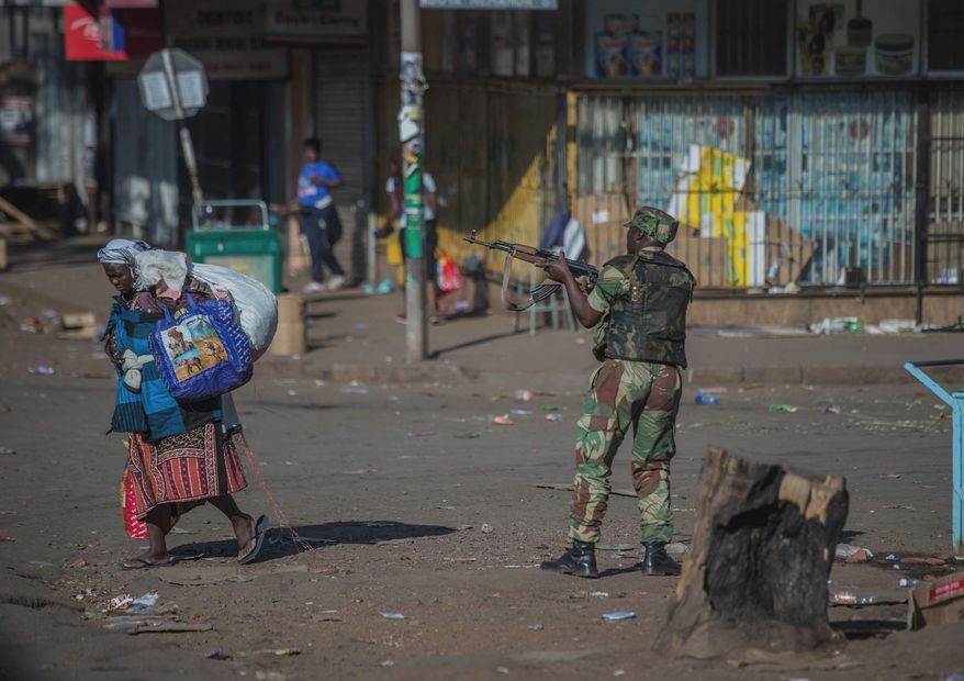 Hundreds of angry opposition supporters outside Zimbabwe's electoral commission were met by riot police firing tear gas as the country awaited the results of Monday's presidential election, the first after the fall of longtime leader Robert Mugabe. (Associated Press)