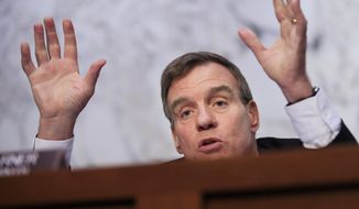 Senate Intelligence Committee ranking member Sen. Mark Warner, D-Va., speaks to witnesses during a committee hearing on foreign influence operations and their use of social media on Capitol Hill in Washington, Wednesday, Aug. 1, 2018. (AP Photo/Manuel Balce Ceneta)