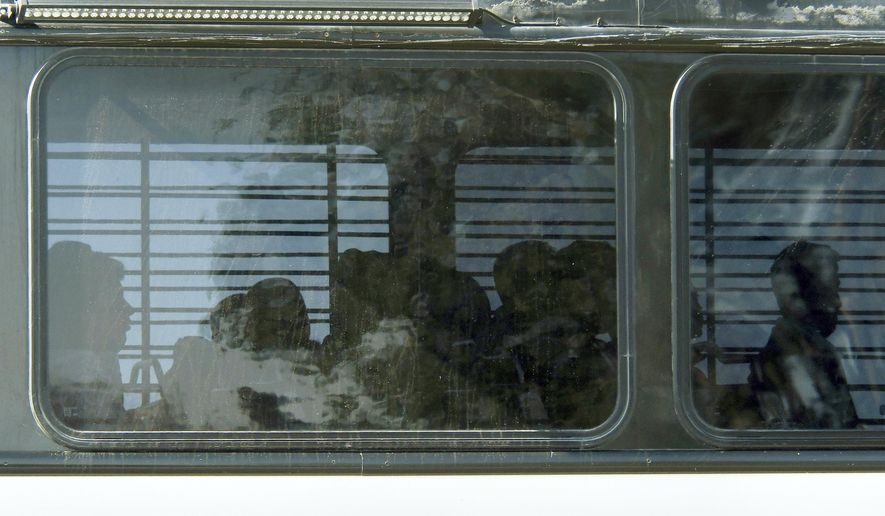 FILE - In this Friday, June 8, 2018, file photo, Department of Homeland Security buses with detained immigrants aboard enter the Federal Correctional Institution in Victorville, Calif., in the Mojave Desert, northeast of Los Angeles. The lawsuit filed Wednesday, Aug. 1, 2018 in federal court in Riverside, Calif., alleges that prison conditions at the medium-security facility are too restrictive for immigrants detained while awaiting immigration court hearings. (James Quigg/The Daily Press via AP, File)