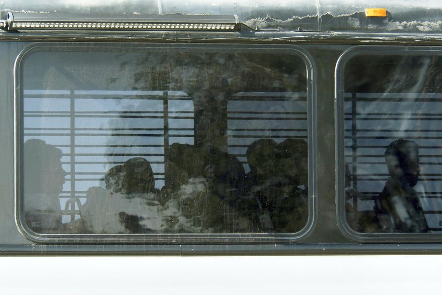 FILE - In this Friday, June 8, 2018, file photo, Department of Homeland Security buses with detained immigrants aboard enter the Federal Correctional Institution in Victorville, Calif., in the Mojave Desert, northeast of Los Angeles. The lawsuit filed Wednesday, Aug. 1, 2018 in federal court in Riverside, Calif., alleges that prison conditions at the medium-security facility are too restrictive for immigrants detained while awaiting immigration court hearings. (James Quigg/The Daily Press via AP, File)