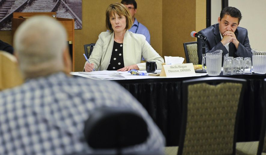 Director of Montana Department of Public Health & Human Services Sheila Hogan, center, and Dan Villa, the governor's budget director, listen to recommendations Wednesday, Aug. 1, 2018, from health and human service providers as the state decides where to restore millions of dollars in funding that had been cut to fill a budget shortfall, in Helena, Mont. (Thom Bridge/Independent Record via AP)