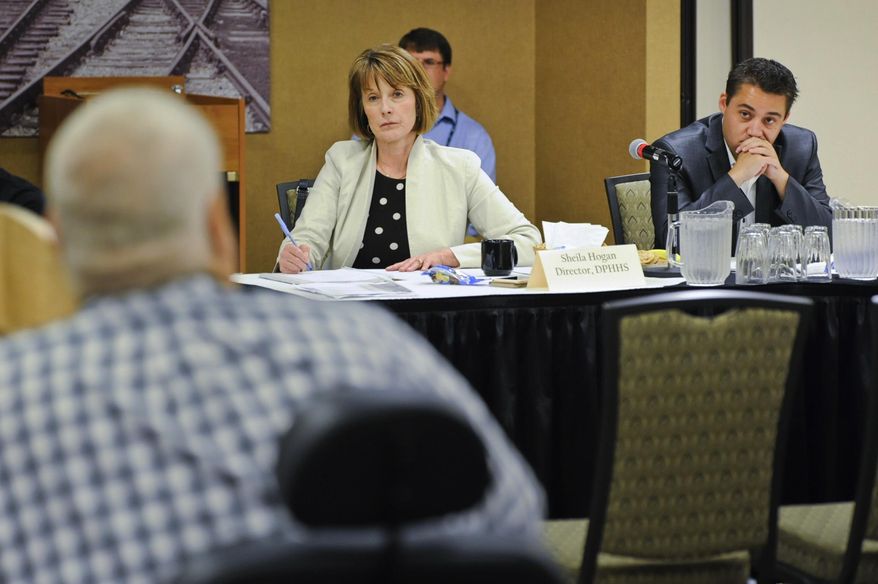 Director of Montana Department of Public Health & Human Services Sheila Hogan, center, and Dan Villa, the governor's budget director, listen to recommendations Wednesday, Aug. 1, 2018, from health and human service providers as the state decides where to restore millions of dollars in funding that had been cut to fill a budget shortfall, in Helena, Mont. (Thom Bridge/Independent Record via AP)