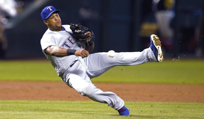 Texas Rangers third baseman Adrian Beltre makes the off balance throw for the out on a ball hit by Arizona Diamondbacks&#x27; Paul Goldschmidt during the first inning during a baseball game Tuesday, July 31, 2018, in Phoenix. (AP Photo/Rick Scuteri)
