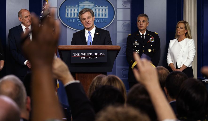 FBI Director Christopher Wray speaks during the daily press briefing at the White House, Thursday, Aug. 2, 2018, in Washington, as from left, Director of National Intelligence Dan Coats, National Security Agency Director Gen. Paul Nakasone, and Secretary of Homeland Security Kirstjen Nielsen listen. (AP Photo/Evan Vucci)