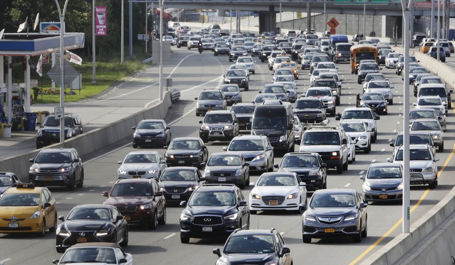 In this Aug. 1, 2018, photo, cars on the Grand Central Parkway pass LaGuardia Airport in New York. The Trump administration has proposed rolling back tougher Obama-era gas mileage requirements that are set to take effect after 2020. (AP Photo/Frank Franklin II)