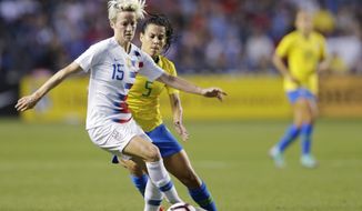 U.S. forward Megan Rapinoe works with the ball in front of Brazil midfielder Thaisa during the fist half of a Tournament of Nations soccer match Thursday, Aug. 2, 2018, in Bridgeview, Ill. (AP Photo/Annie Rice)