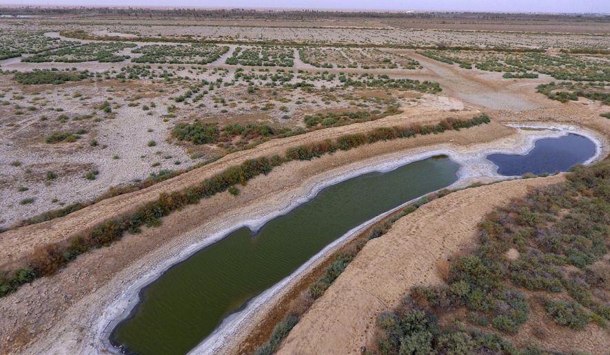 This canal southeast of Baghdad is dry and filled with salt. Iraq, historically known as &quot;The Land Between The Two Rivers,&quot; is struggling with the scarcity of water because of dams in Turkey and Iran, a lack of rainfall and aging hydrological infrastructure. The decreased water levels have dramatically affected agriculture and animal resources. (Associated Press/File)