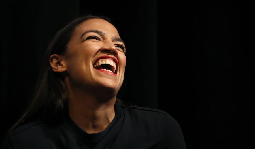 New York congressional candidate Alexandria Ocasio-Cortez laughs while listening to a speaker at a fundraiser Thursday, Aug. 2, 2018, in Los Angeles. The 28-year-old startled the party when she defeated 10-term U.S. Rep. Joe Crowley in a New York City Democratic primary. (AP Photo/Jae C. Hong)