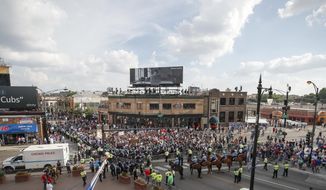 Protesters arrive at Wrigley Field to demand more government action against gun violence, Thursday, Aug. 2, 2018, in Chicago. (AP Photo/Kamil Krzaczynski)
