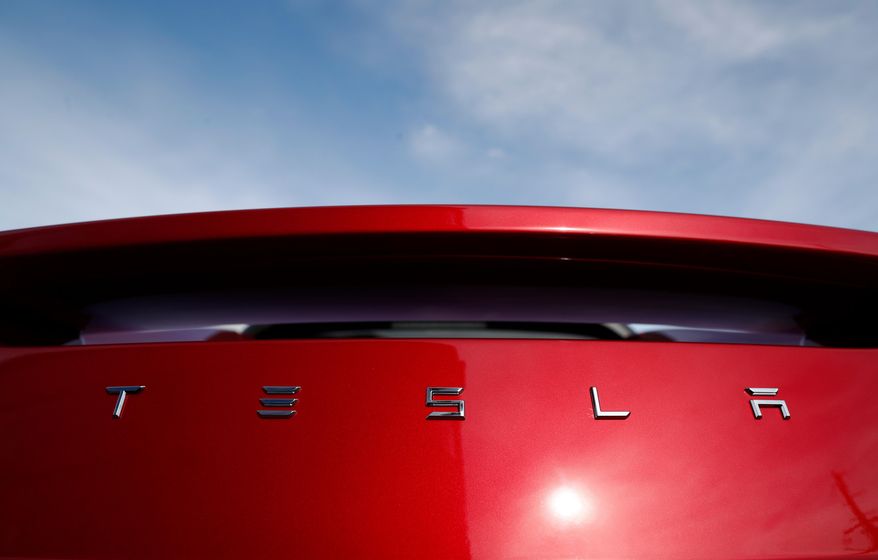 FILE - In this April 15, 2018, file photo, the sun shines off the rear deck of a roadster on a Tesla dealer's lot in the south Denver suburb of Littleton, Colo. Martin Tripp, a former Tesla Inc. employee at the electric car maker's battery plant in Nevada, is seeking at least $1 million in defamation damages after it accused him of hacking into computers and stealing confidential information leaked to the media. His lawyers filed a counterclaim in federal court in Reno, Nev., Tuesday, Aug. 2. (AP Photo/David Zalubowski, File)
