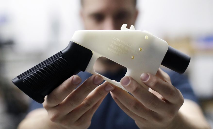 FILE--In this Aug. 1, 2018, file photo, Cody Wilson, with Defense Distributed, holds a 3D-printed gun called the Liberator at his shop in Austin, Texas. Eleven states have joined eight others and the District of Columbia in a federal lawsuit that seeks to block a settlement the Trump administration reached with a company that wants to post online plans to make 3D firearms on a printer. (AP Photo/Eric Gay)
