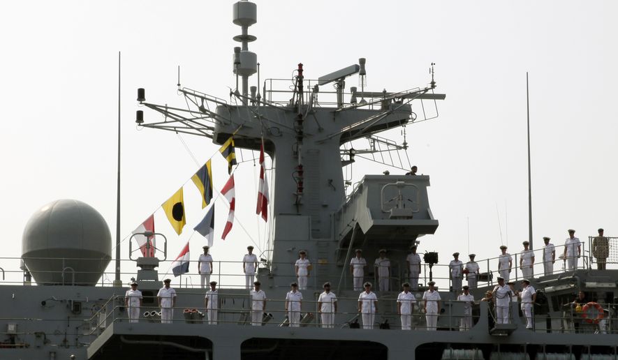 Sailors of British Royal Navy&#39;s HMS Albion amphibious assault ship man the rails upon arrival at a dock in Tokyo Friday, Aug. 3, 2018. The British warship has docked in Tokyo as Britain seeks to expand its military presence in the Asia-Pacific region. (AP Photo/Ken Moritsugu)