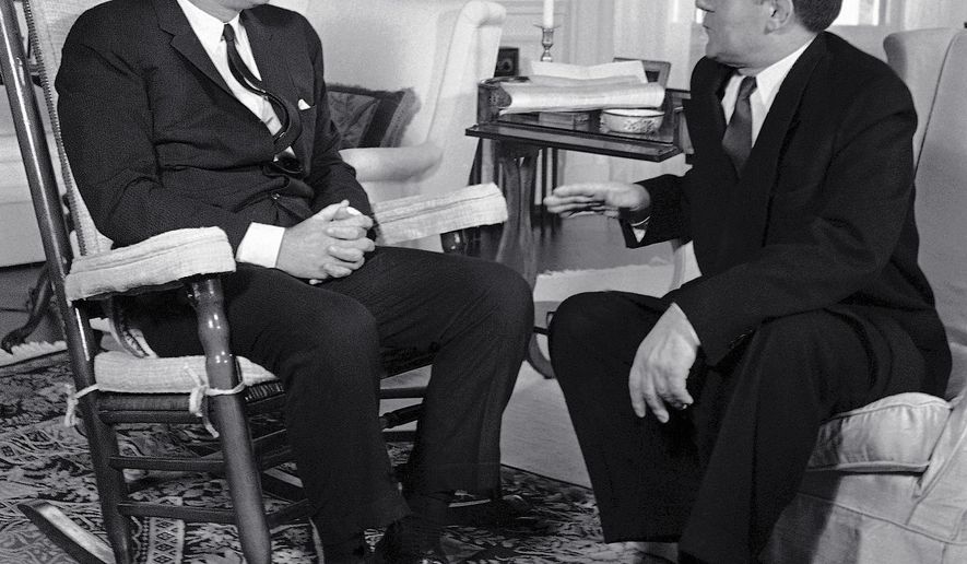 FILE - In this Oct. 6, 1961, file photo, President John F. Kennedy, left, sits in his rocker in the White House in Washington, as he talks with Soviet Foreign Minister Andrei Gromyko about the Berlin situation. Beginning Friday, Aug. 3, 2018, Eldred's auction gallery in East Dennis, Mass., on Cape Cod, is auctioning items associated with the late president, including a rocking chair that Kennedy used in the White House. (AP Photo/Bob Schutz, File)