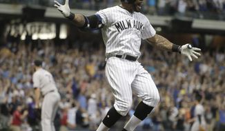 Milwaukee Brewers&#39; Eric Thames celebrates after hitting a three-run walk off home run during the ninth inning of a baseball game against the Colorado Rockies Friday, Aug. 3, 2018, in Milwaukee. The Brewers won 5-3. (AP Photo/Morry Gash)