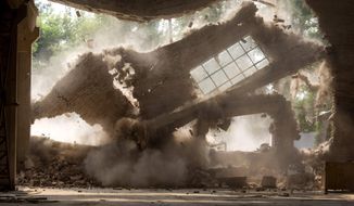 Walls of Chinese artist Ai Weiwei&#39;s studio collapse during demolition in Beijing Saturday, Aug. 4, 2018. The frequent government critic says on his Instagram account the demolition began Friday without prior notice and posted videos of an excavator smashing the windows of his &amp;quot;Zuoyou&amp;quot; studio. (AP Photo/Ng Han Guan)
