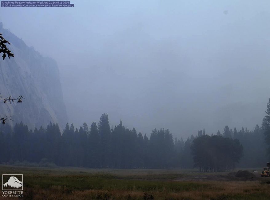 In this Wednesday, Aug. 1, 2018 image from a Yosemite Conservancy webcam, smoke from wildfires obscures the Ahwahnee Meadow at Yosemite National Park, Calif. Yosemite National Park could reopen its scenic valley and other areas Monday, Aug. 6, 2018, if conditions improve after a 12-day closure due to nearby wildfires. The park’s iconic cliffs have been shrouded in so much smoke that the air quality in Yosemite is currently worse than Beijing. (Webcam by Yosemite Conservancy via AP)