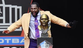 Former Baltimore Ravens linebacker Ray Lewis dances beside his bust as he delivers his induction speech at the Pro Football Hall of Fame Saturday, Aug. 4, 2018, in Canton, Ohio. (AP Photo/David Richard)