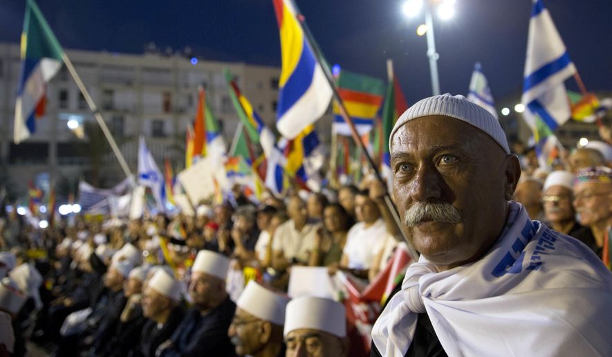 Israelis from the Druze community participate in a rally against Israel's Jewish Nation bill in Tel Aviv, Israel, Saturday, Aug. 4, 2018. Thousands of members of Israel's Druze minority and their Jewish supporters packed a central Tel Aviv square Saturday night to rally against a contentious new law that critics say sidelines Israel's non-Jewish citizens. (AP Photo/Sebastian Scheiner)