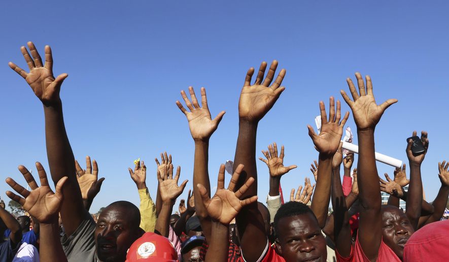 Supporters of presidential candidate Nelson Chamisa raise their hands in support during his last rally in Harare, Zimbabwe, on Saturday, July, 28, 2018. On Thursday, the Zimbabwe Electoral Commission said President Emmerson Mnangagwa won the first election without Robert Mugabe on the ballot, ending a tumultuous week that began with optimistic scenes of peaceful voting, turned ugly with a deadly crackdown by soldiers in Harare, and ended with the prospect of a legal challenge over the result. (AP Photo/Tsvangirayi Mukwazhi)