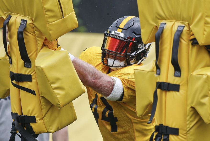 FILE-In this file photo from June 13, 2018, Pittsburgh Steelers linebacker Tyler Matakevich goes through drills during an NFL football practice in Pittsburgh. Matakevich and Jon Bostic find themselves in a battle for a starting inside linebacker spot in the Steelers defense. Both are attempting to fill the void left by the injured Ryan Shazier. (AP Photo/Keith Srakocic, File)