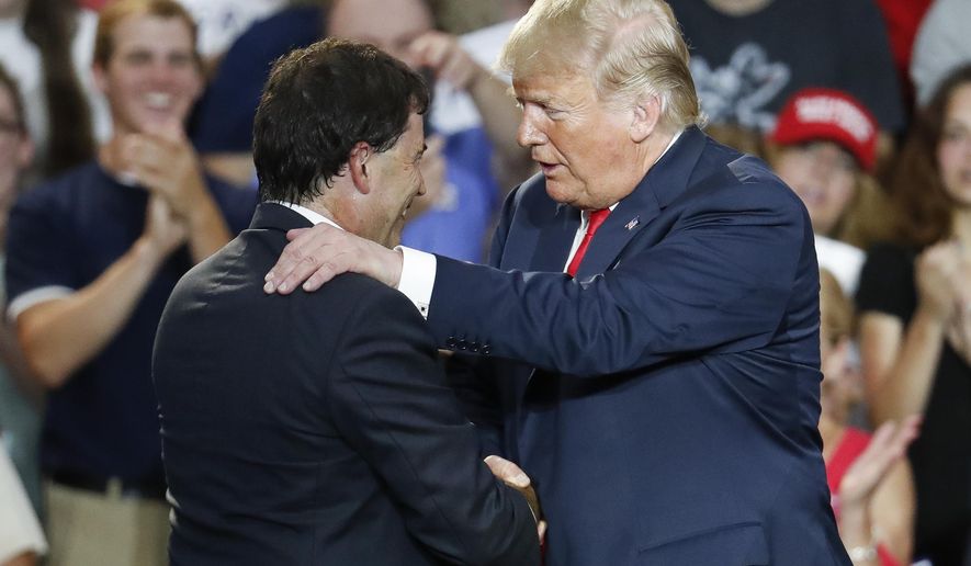 President Donald Trump, right, shakes hands with 12th Congressional District Republican candidate Troy Balderson, left, during a rally, Saturday, Aug. 4, 2018, in Lewis Center, Ohio. (AP Photo/John Minchillo)