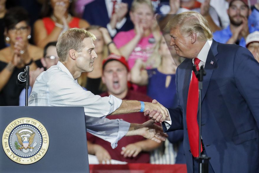 President Donald Trump, right, shakes hands with Rep. Jim Jordan, R-Ohio, left, during a rally, Saturday, Aug. 4, 2018, in Lewis Center, Ohio. (AP Photo/John Minchillo) ** FILE **