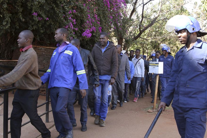 Opposition party supporters arrested during a raid at the party headquarters appear at the magistrates court in Harare, Zimbabwe, Saturday, Aug, 4, 2018. Zimbabwean President-elect Emmerson Mnangagwa won an election Friday with just over 50 percent of the ballots as the ruling party maintained control of the government in the first vote since the fall of longtime leader Robert Mugabe. (AP Photo)