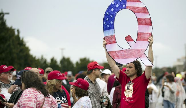 David Reinert displayed a Q sign at a Pennsylvania campaign rally Thursday with President Trump and Senate candidate Lou Barletta. (Associated Press)