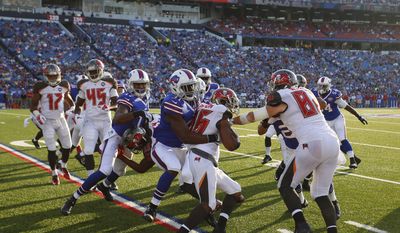 Tampa Bay Buccaneers kick returner Solomon Patton (86) is stopped by Kenny Ladler (31) during the second half of a preseason NFL football game against the Buffalo Bills Saturday, Aug. 23, 2014, in Orchard Park, N.Y. (AP Photo/Bill Wippert)