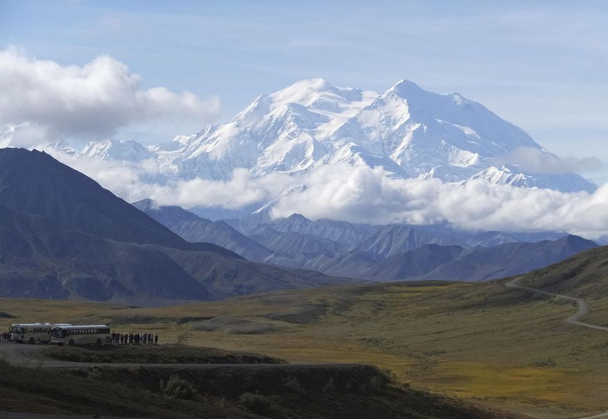 FILE - In this Aug. 26, 2016, file photo sightseeing buses and tourists are seen at a pullout popular for taking in views of North America's tallest peak, Denali, in Denali National Park and Preserve, Alaska. Rescuers are attempting to locate a sightseeing plane that crashed with the pilot and four passengers aboard high on a mountain ridge in Denali National Park and Preserve. The pilot reported on his satellite phone Saturday, Aug. 4, 2018, that there were some injuries but authorities couldn't get details before the satellite connection dropped. (AP Photo/Becky Bohrer, File)