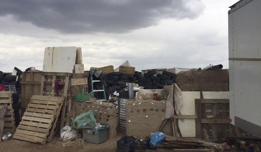 This Friday, Aug. 3, 2018, photo released by Taos County Sheriff's Office shows a rural compound during an unsuccessful search for a missing 3-year-old boy in Amalia, N.M. Law enforcement officers searching the compound for the missing child didn't locate him but found 11 other children in filthy conditions and hardly any food, a sheriff said Saturday. The children ranging in age from 1 to 15 were removed from the compound and turned over to state child-welfare workers, Taos County Sheriff Jerry Hogrefe said.in Taos, N.M. (Taos County Sheriff's Office via AP)