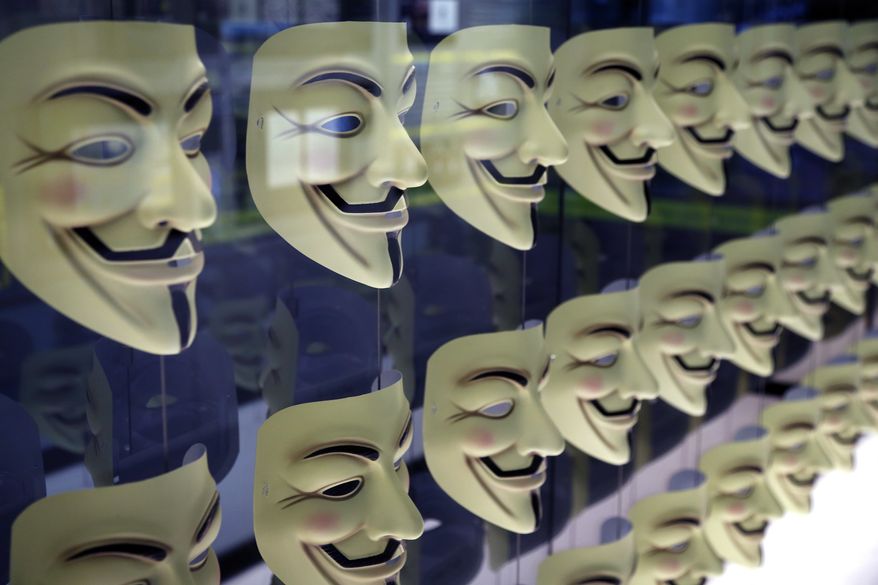 In this Monday, Feb. 12, 2018, file photo, Guy Fawkes masks, often associated with the hacker group Anonymous, are displayed in a section about hacking at SPYSCAPE in New York. (AP Photo/Seth Wenig) ** FILE **