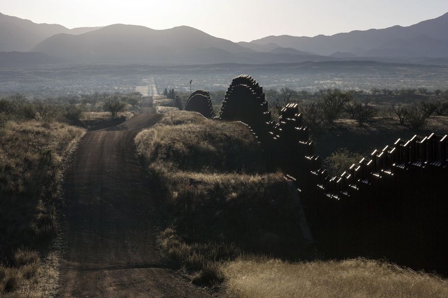 The U.S.-Mexico border fence seen on the outskirts of Nogales in southern Arizona. A U.S. border patrol agent is going on trial for second-degree murder in U.S. District Court in Tucson on Tuesday, March 20, 2018, in a rare Justice Department prosecution of a fatal cross-border Mexico shooting. (AP Photo/Brian Skoloff, File)