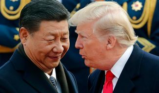 In this Nov. 9, 2017, file photo, U.S. President Donald Trump, right, chats with Chinese President Xi Jinping during a welcome ceremony at the Great Hall of the People in Beijing. (AP Photo/Andy Wong, File)